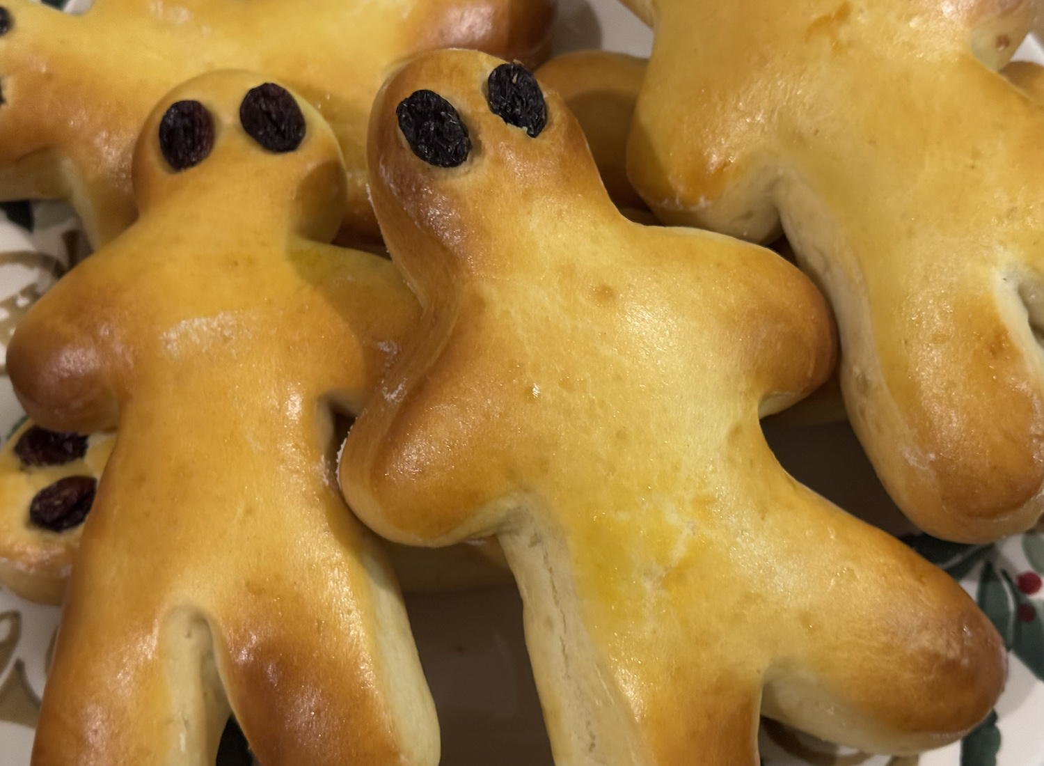 A few men-shaped golden brioche with raisins for eyes.